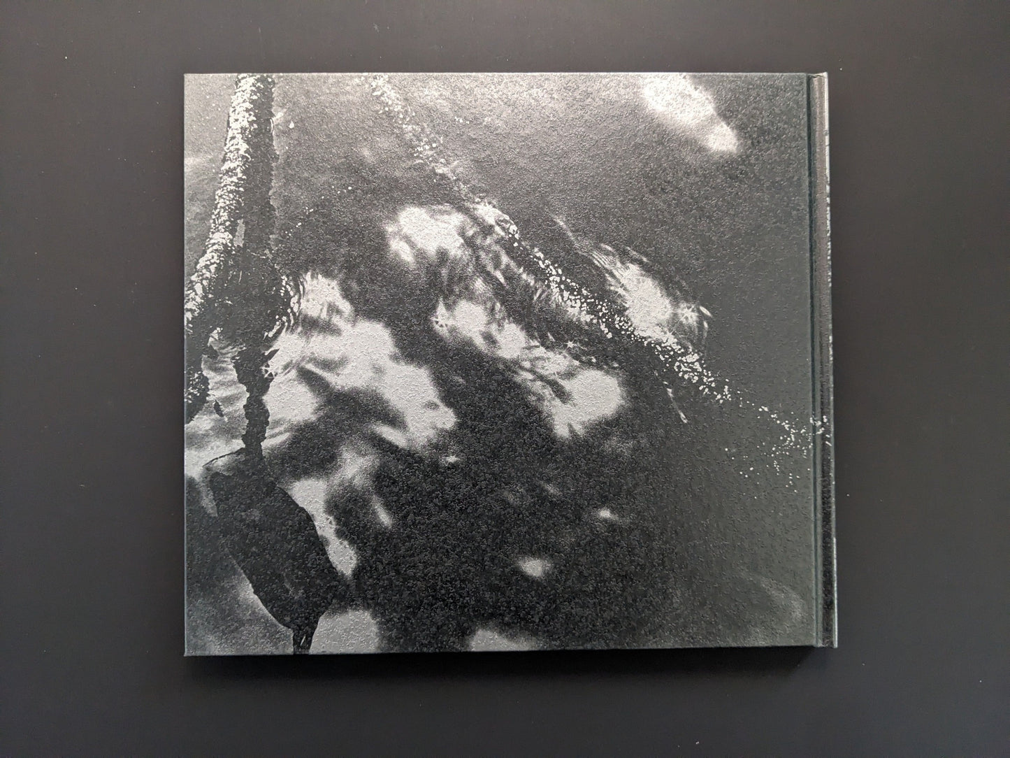 Back cover of the photobook 1980s Remnants by Daido Moriyama with abstract black and white design