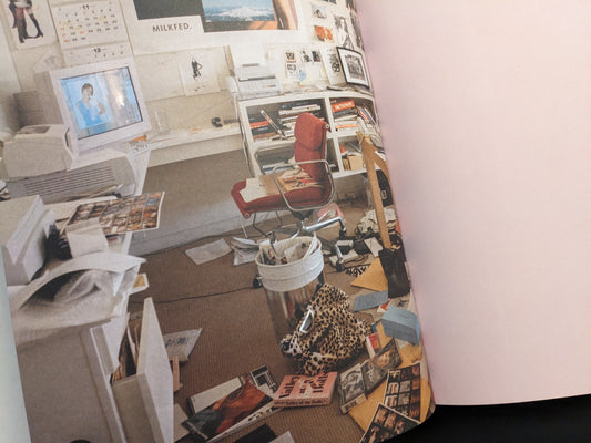 Image from Archive by Sofia Coppola showing a cluttered creative workspace with computer, photos, and film materials