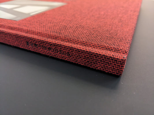 Close-up of the red cloth spine of Berg Werk photobook by Sincei Yamamoto, Sokyusha