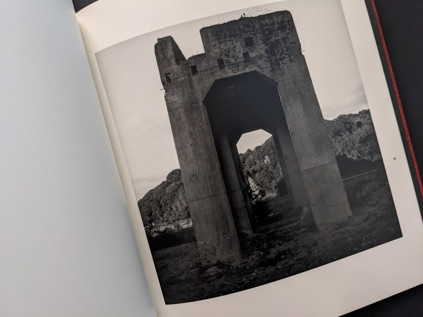 Large concrete mining structure in a desolate landscape, from Berg Werk by Sincei Yamamoto