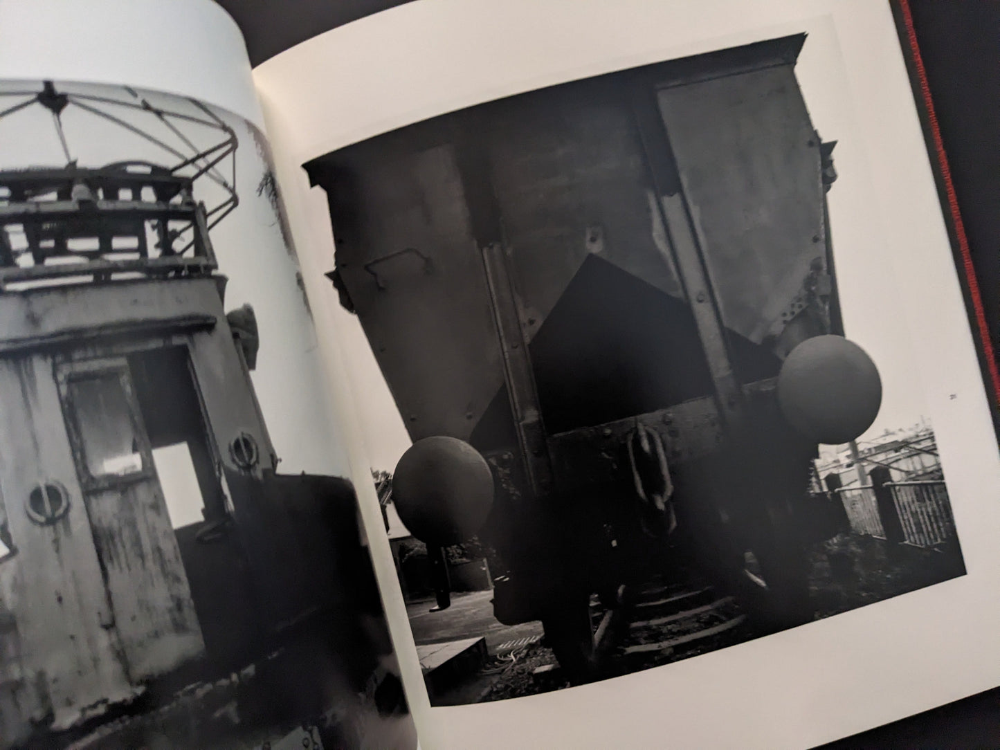 Black and white photograph of an abandoned industrial train cabin and mining equipment from Berg Werk by Sincei Yamamoto