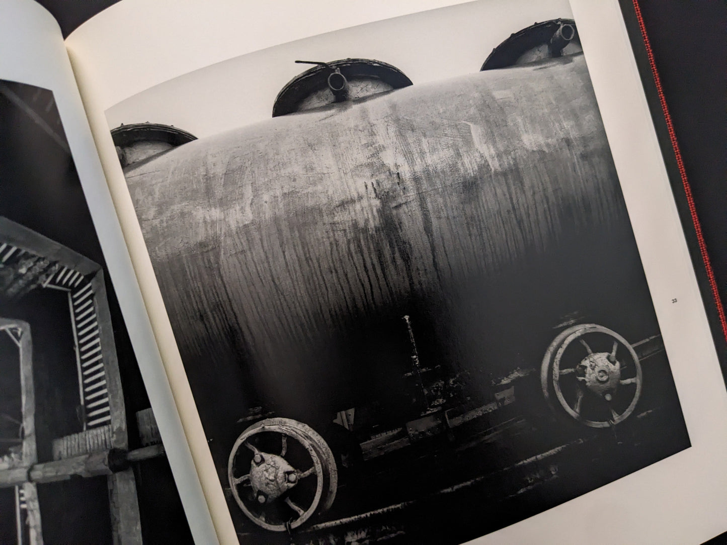 Close-up of a rusted industrial tank with valve wheels, from Berg Werk by Sincei Yamamoto