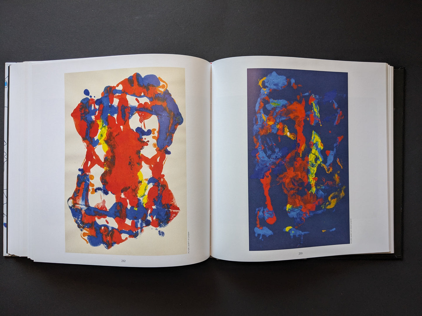 Chaotic surreal forms in red, blue, and yellow.
