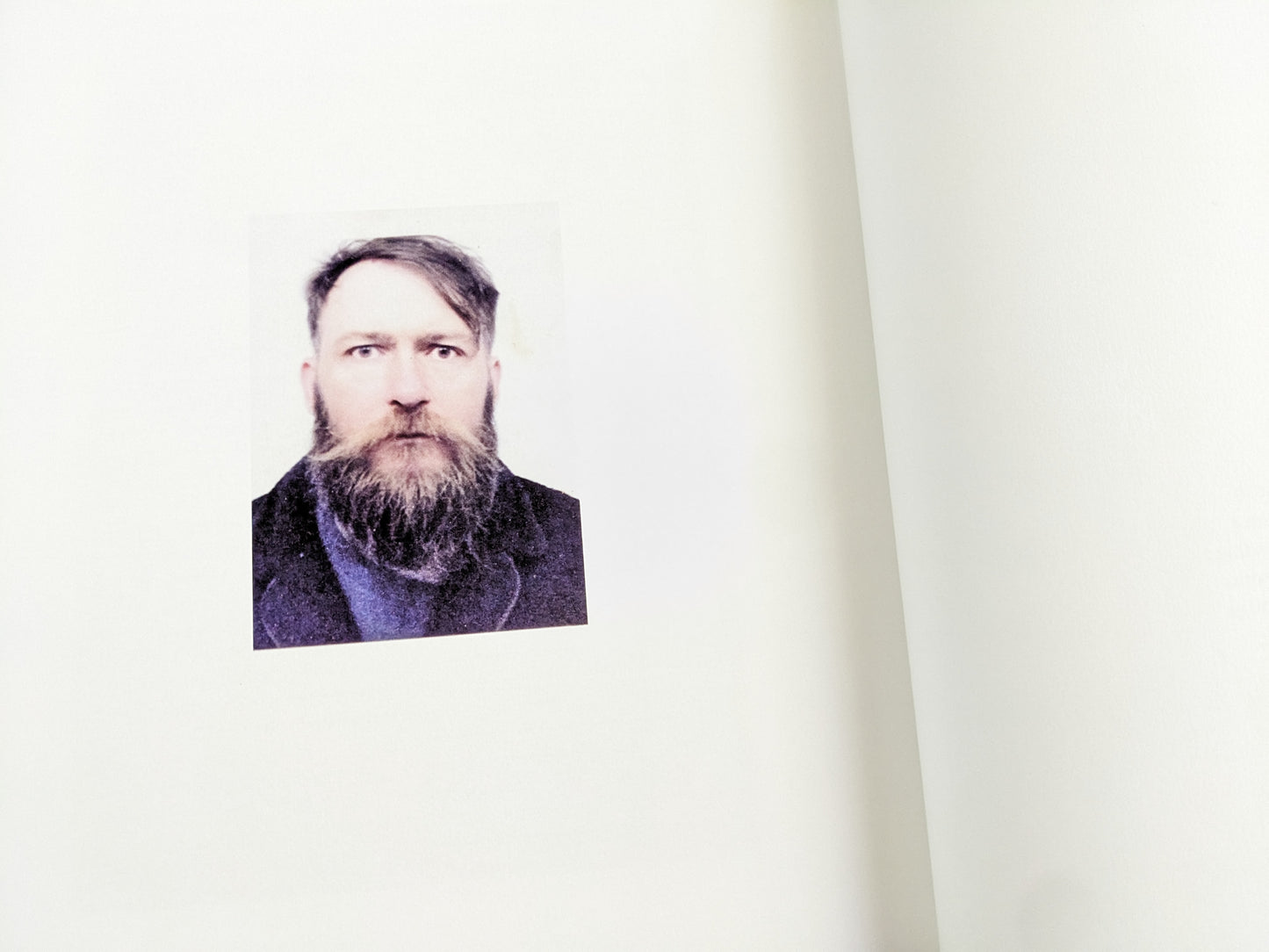 Passport-style color portrait of John Balance with a serious expression