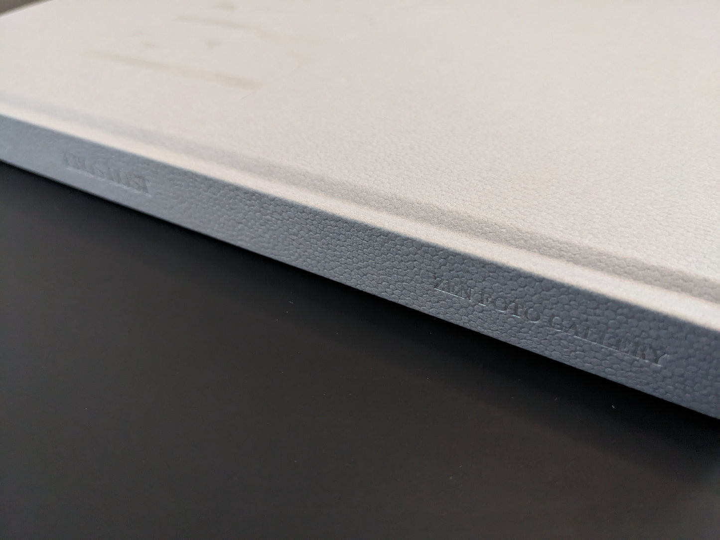 Close-up of the embossed hardcover spine of Seiji Kurata’s photobook Eros Lost, published by Zen Foto Gallery.