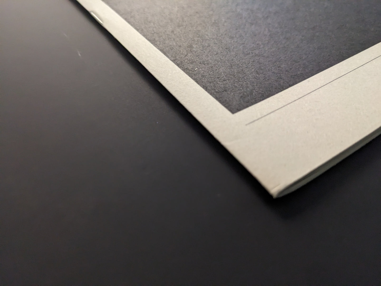 Detail of Far East Obsession photobook corner showing print and paper texture.