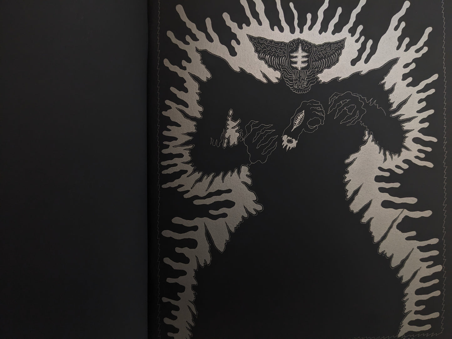 Full-page silver ink illustration of a monstrous humanoid figure surrounded by radiating aura.