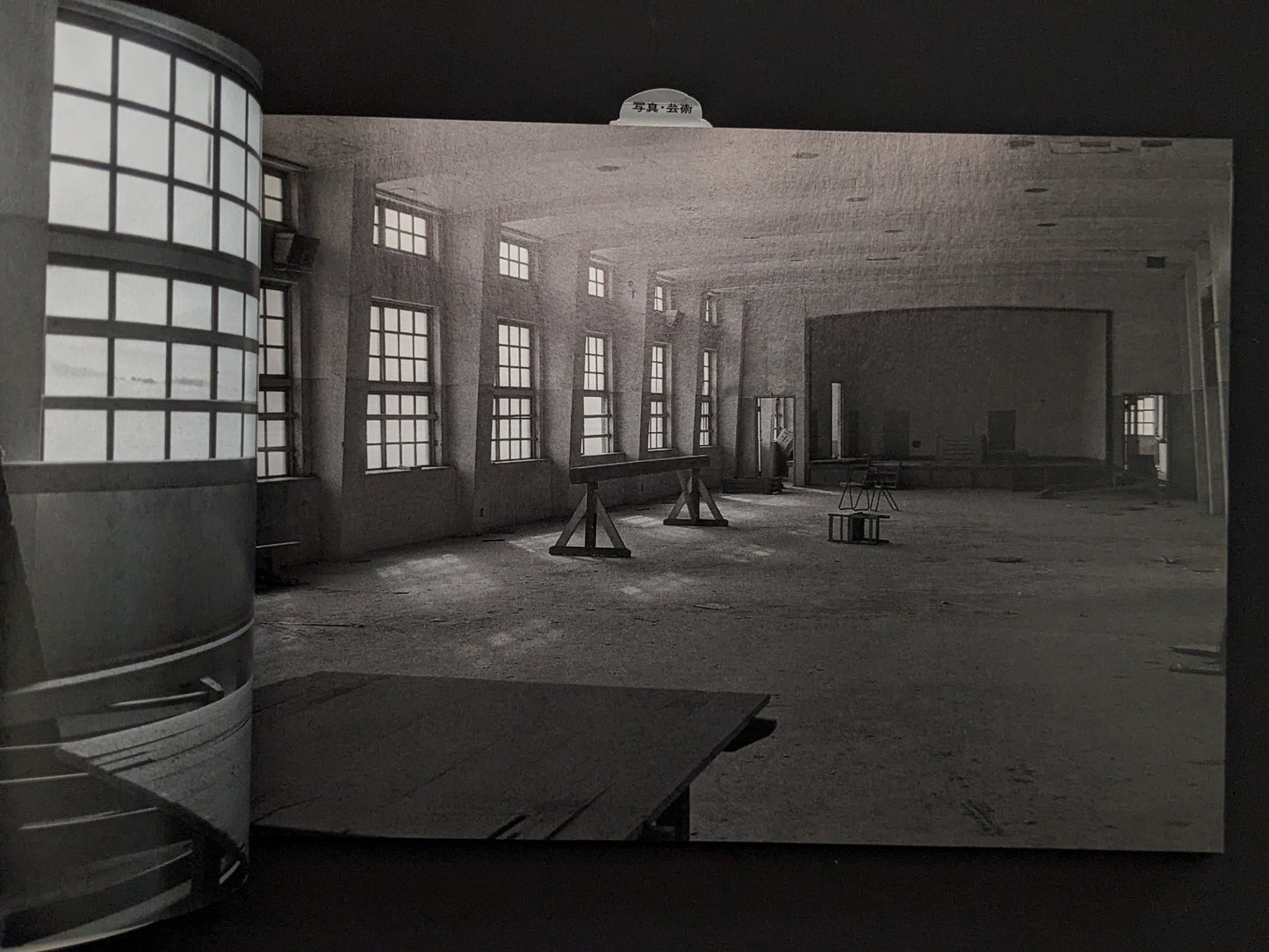 Interior view of an empty hall with windows in the ruins of Hashima Island