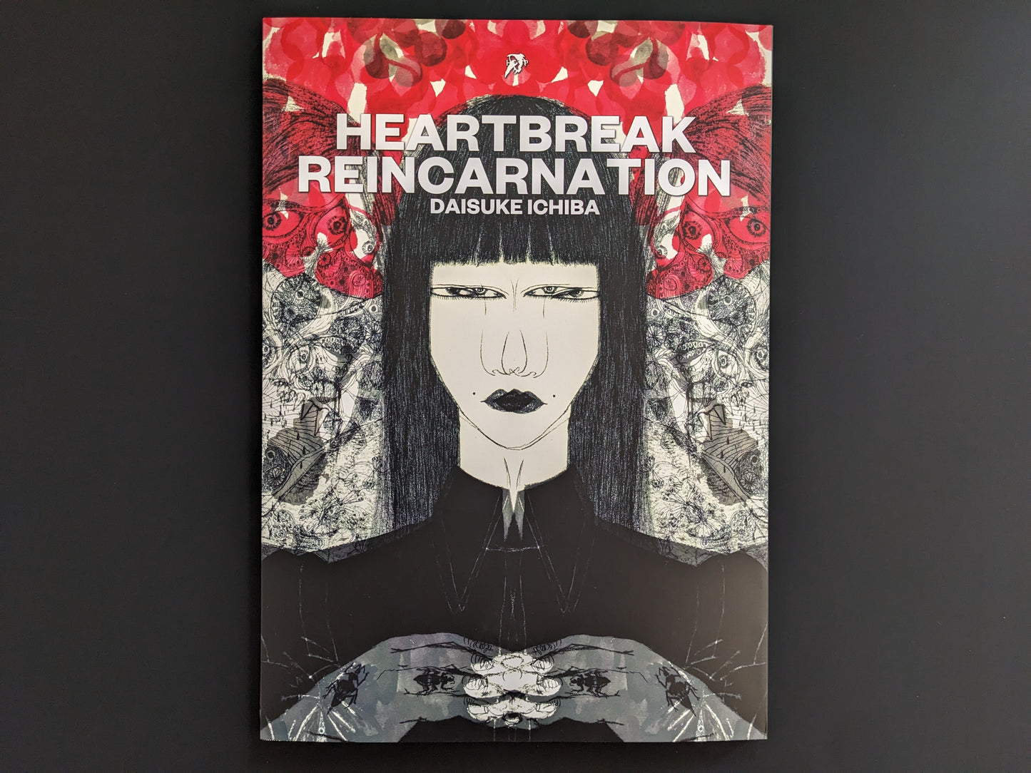 Book cover of 'Heartbreak Reincarnation' by Daisuke Ichiba with a stylized illustration of a woman against a red and black background.