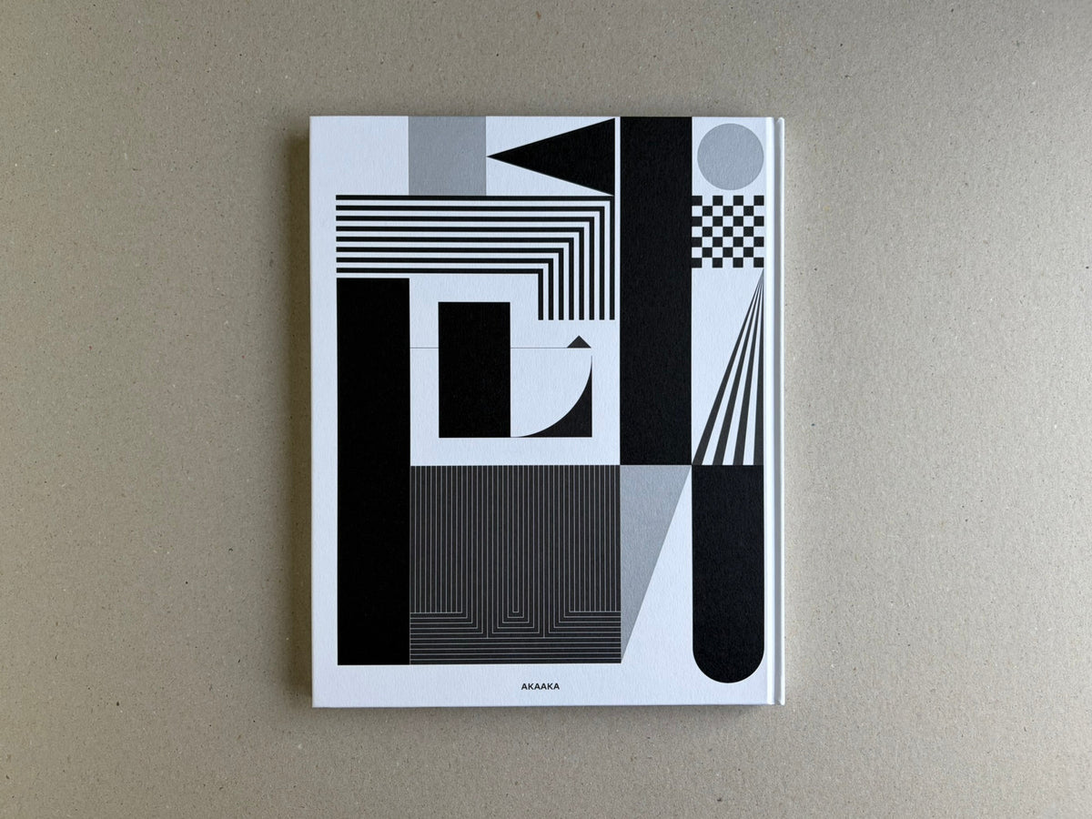 Homo Ludens back cover with black, grey, and white geometric design and AKAAKA logo