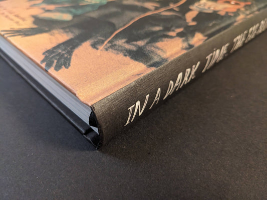 Spine detail of In a Dark Time, the Eye Begins to See by Julia Soboleva, with white title lettering on black cloth.