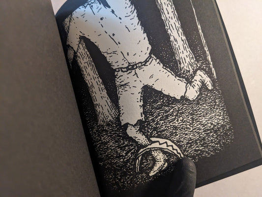 Interior page with a figure trapped in a dark forest, rendered in black and white.