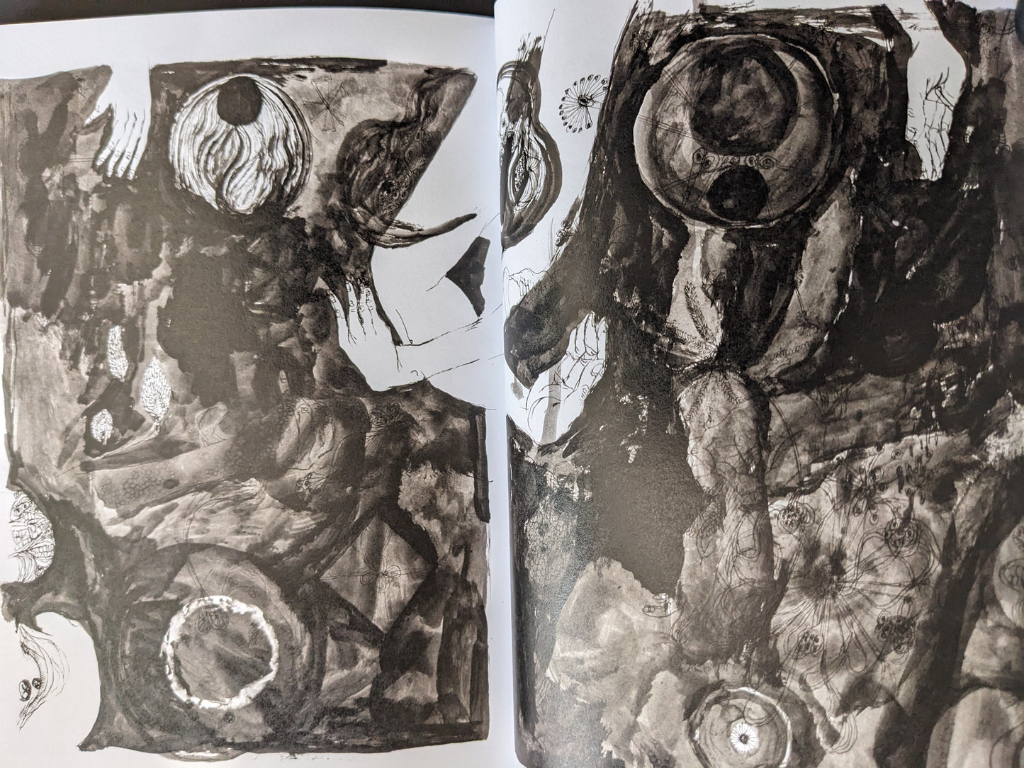 Abstract spread from "KSKHH" by Daisuke Ichiba featuring dark surreal imagery and organic textures