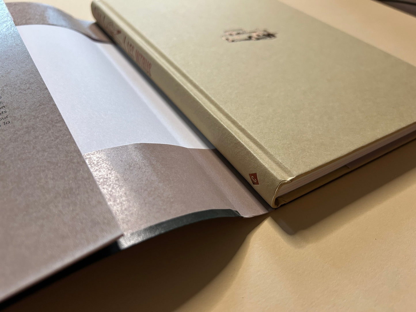 Les Intrus shown partly open, with the cover and page edges visible