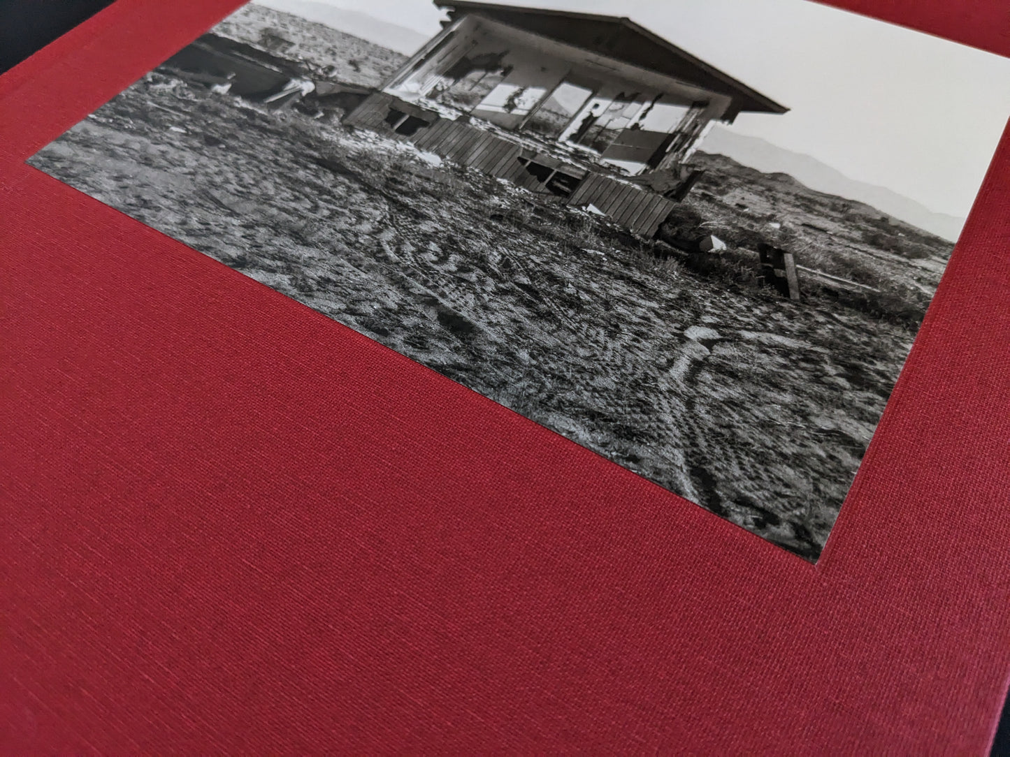 Close-up of the tipped-in cover image and red cloth binding of "Message from the Exterior" by Mark Ruwedel