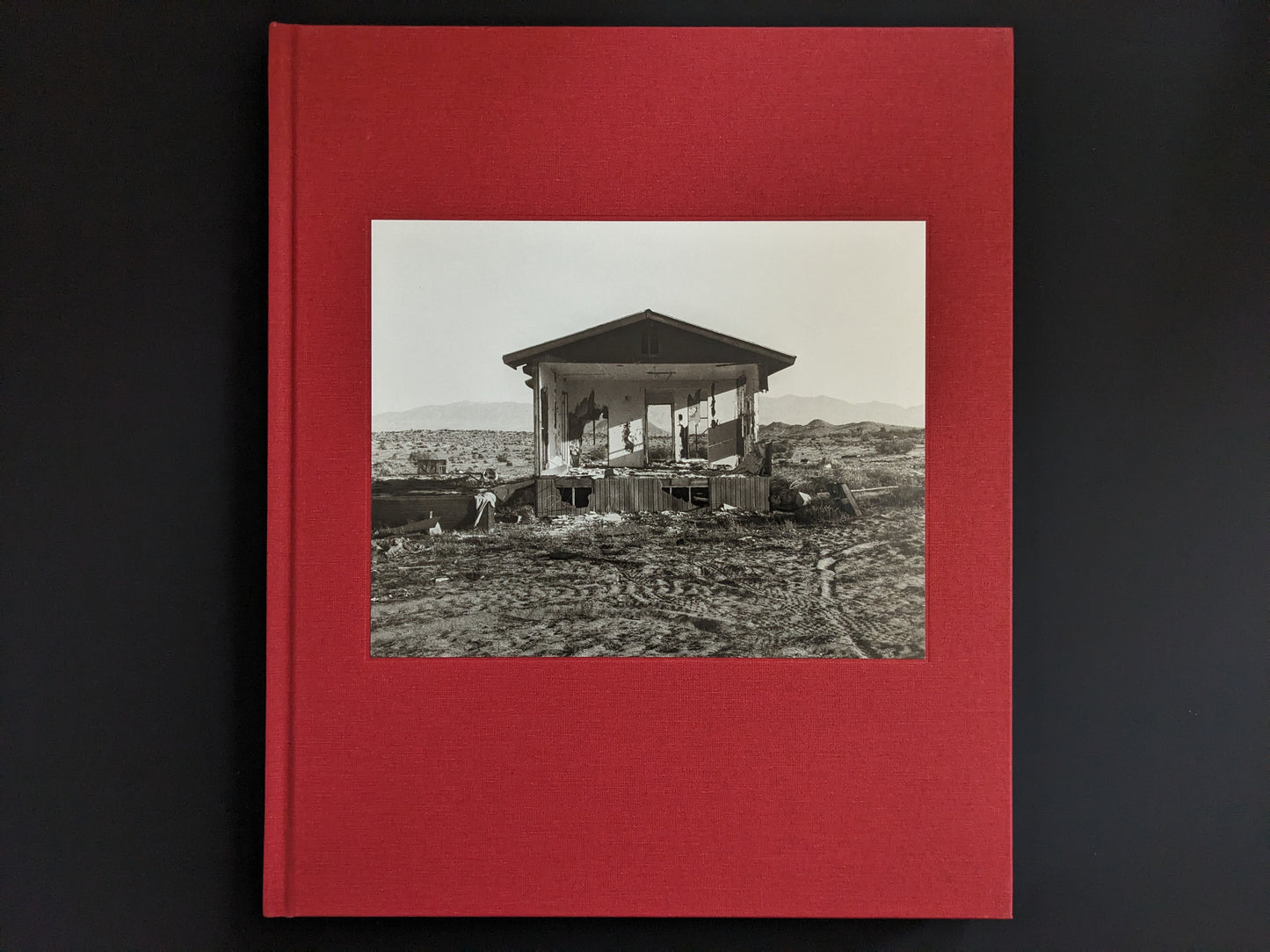 Cover of the book 'Message from the Exterior' by Mark Ruwedel with tipped-in black-and-white photo on red cloth.