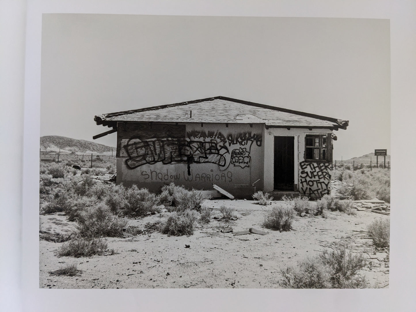 Desert house covered in graffiti photographed by Mark Ruwedel