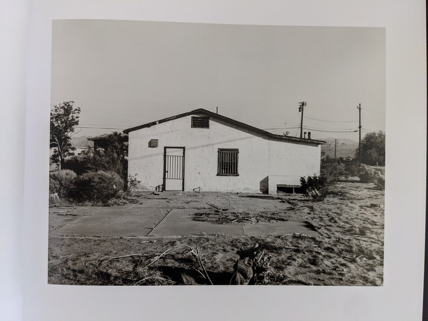 Back view of a deteriorating building in a desert landscape