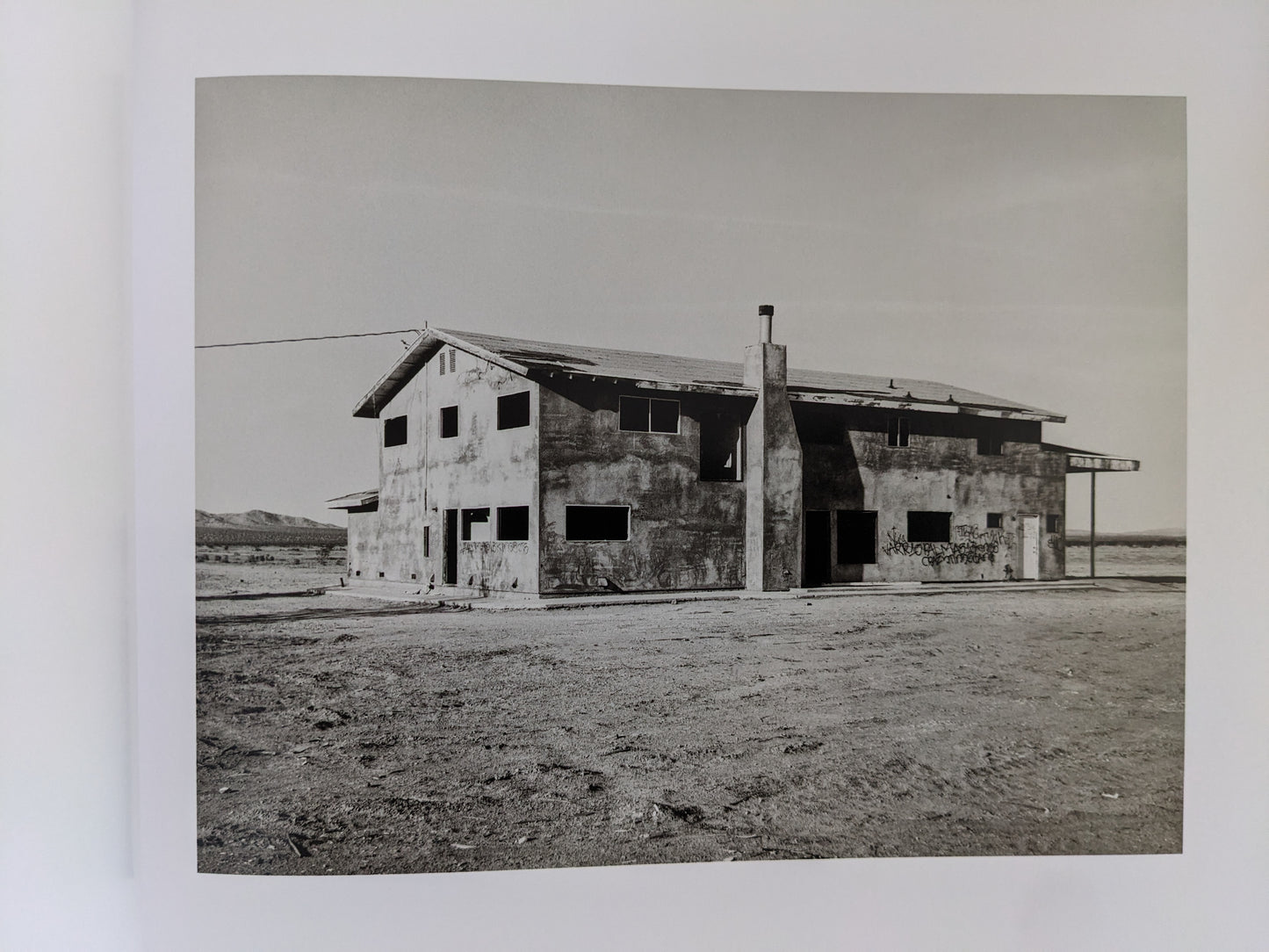 Abandoned two-story desert structure captured in "Message from the Exterior"