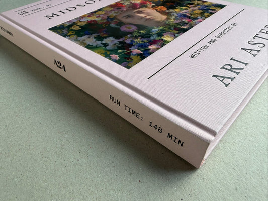 Midsommar Screenplay Book by Ari Aster, shown as a white hardcover book with a floral cover image and visible spine text.