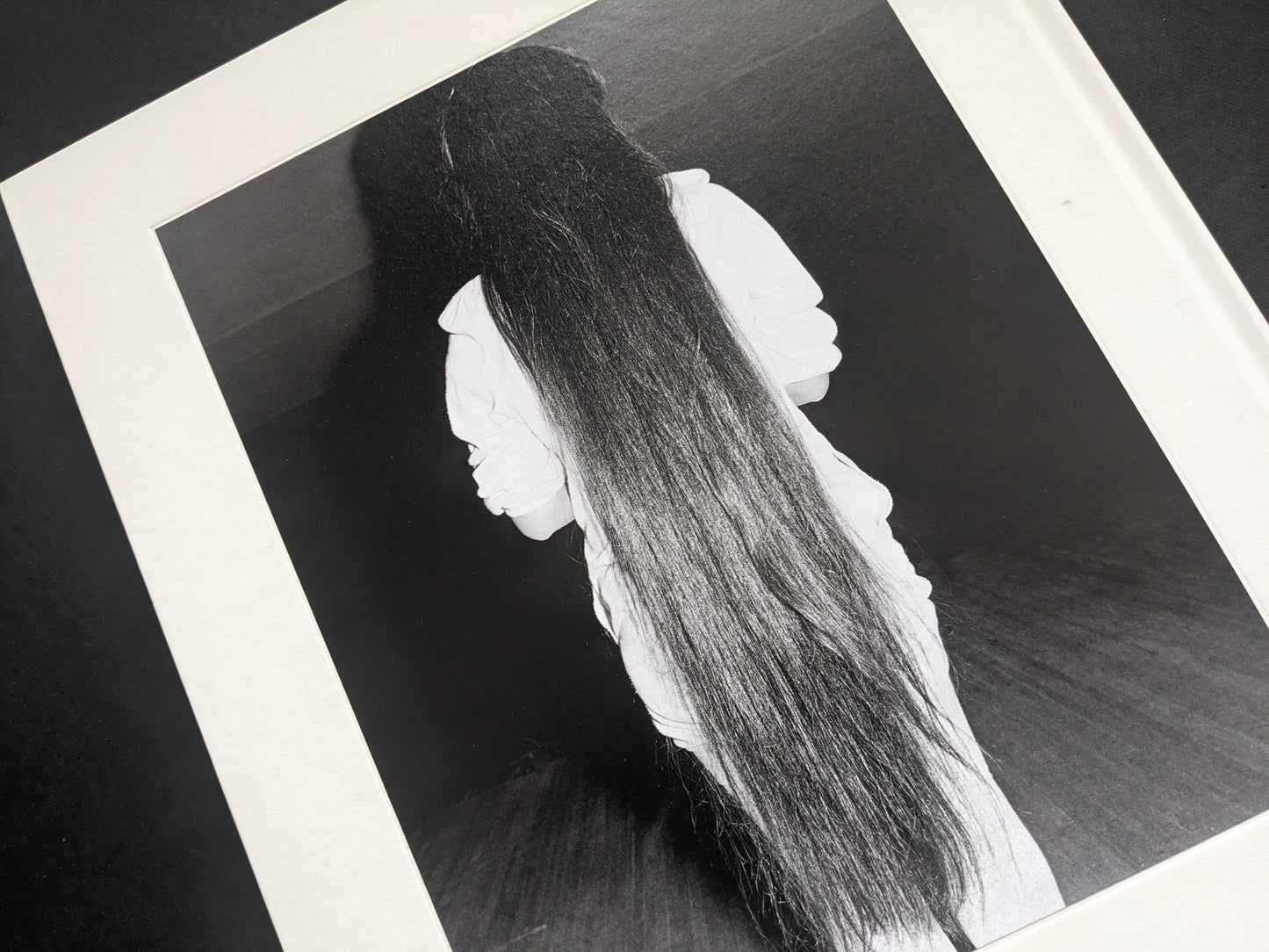 Black-and-white photograph from Mimi Plumb’s Landfall showing a reclining figure with long hair.