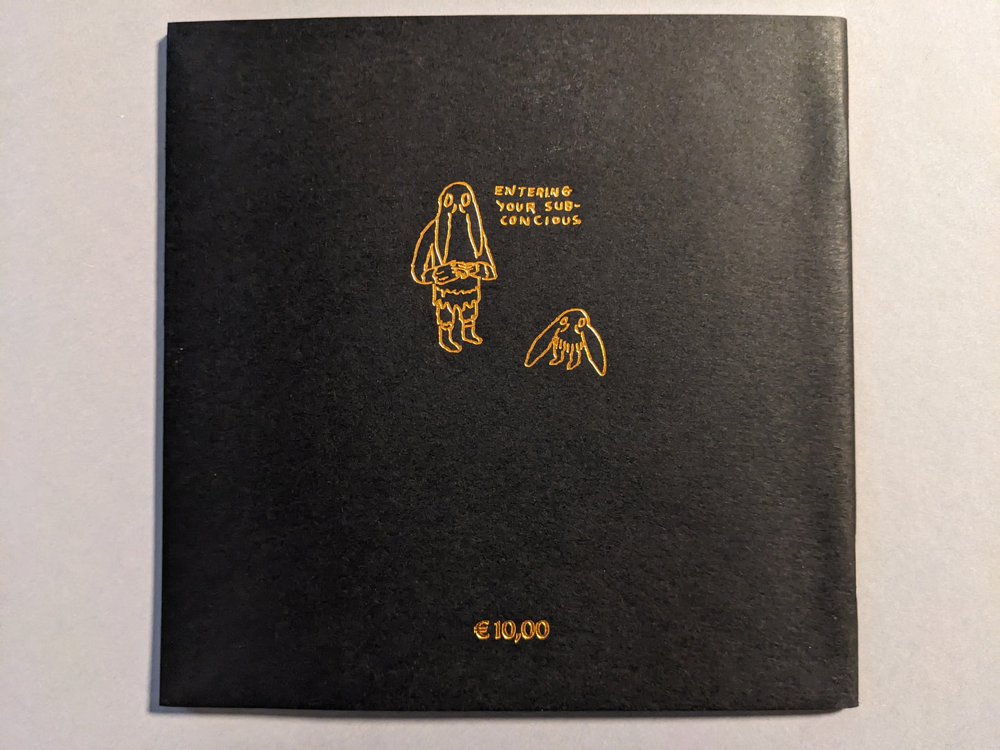Back cover of Multiforce Shit by Mat Brinkman, bronze print on black paper