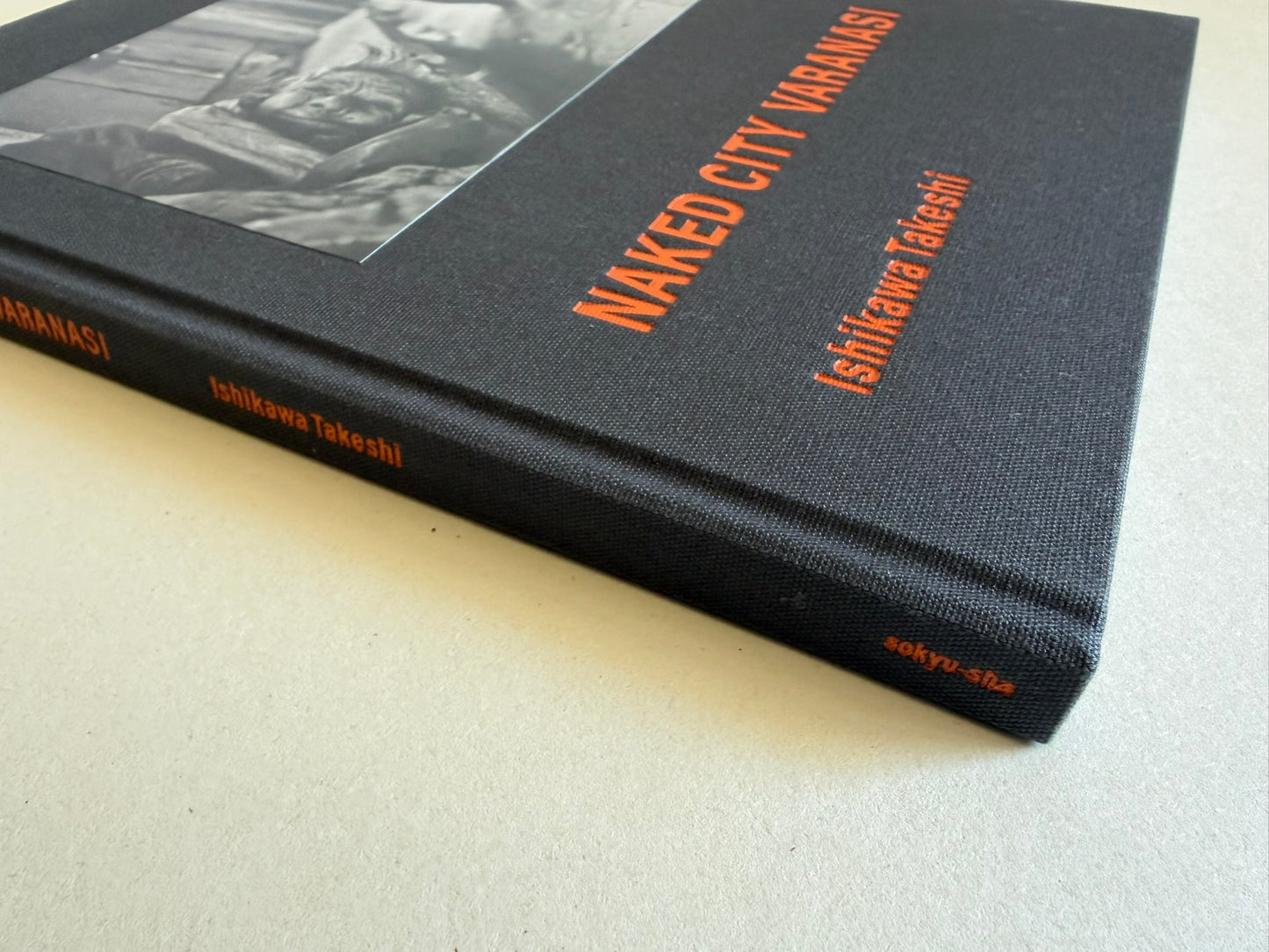 Angled view of the clothbound cover and spine of Naked City Varanasi by Takeshi Ishikawa.