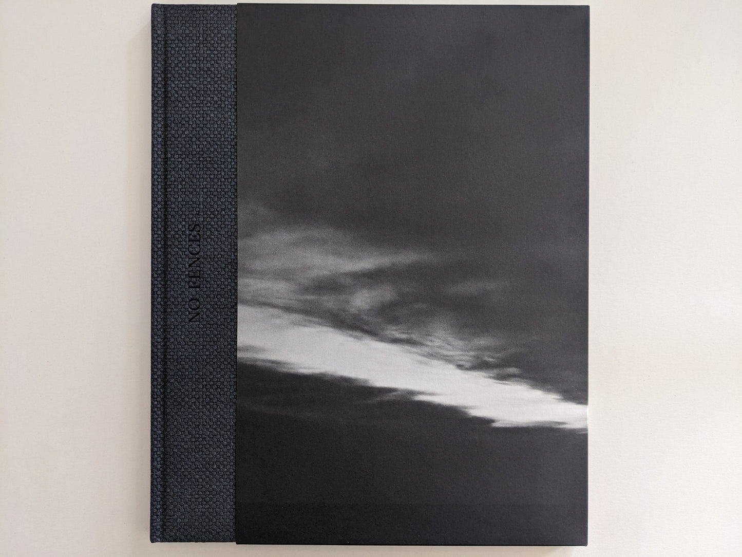 Front cover of 'No Fences' featuring a black-and-white cloud formation over a dark landscape