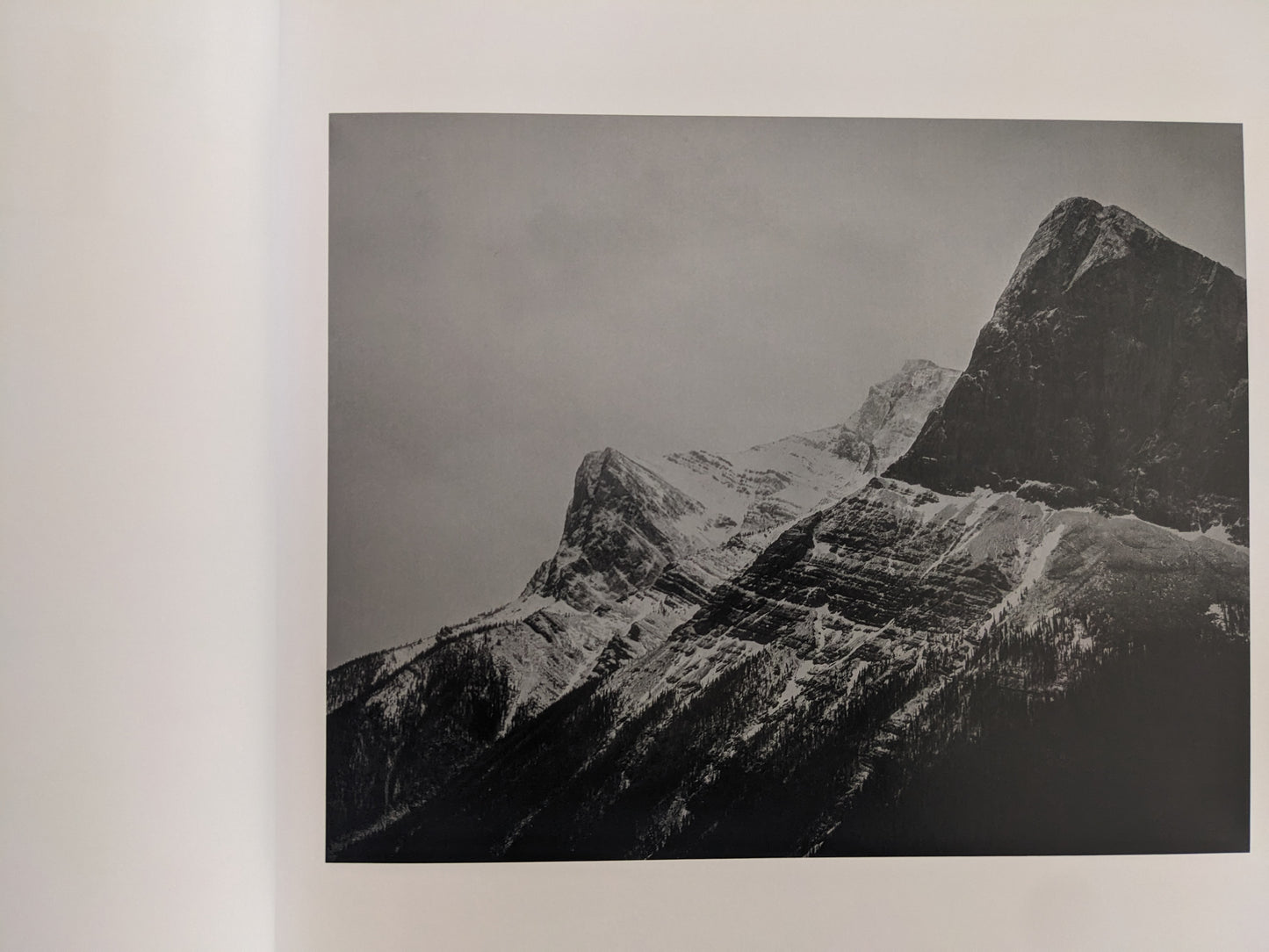 Black-and-white landscape photograph of snow-covered mountains from 'No Fences'