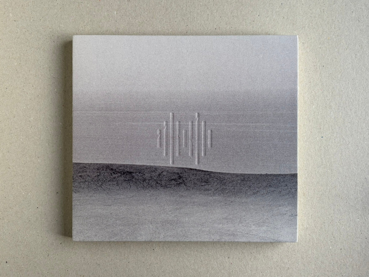 Nusa by Masao Yamamoto, back cover on a grey surface