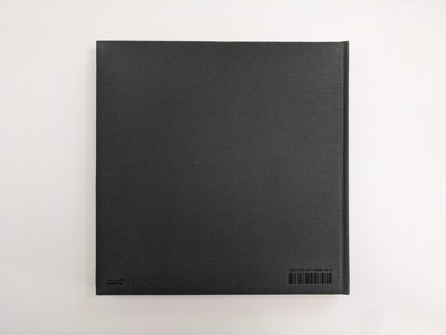Back cover of Oleksandr Glyadyelov photobook, plain grey cloth hardcover by IST Publishing.