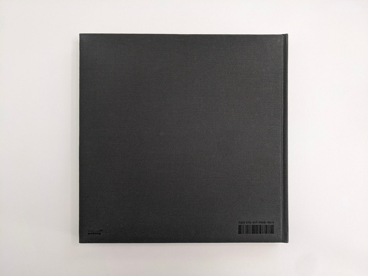 Back cover of Oleksandr Glyadyelov photobook, plain grey cloth hardcover by IST Publishing.