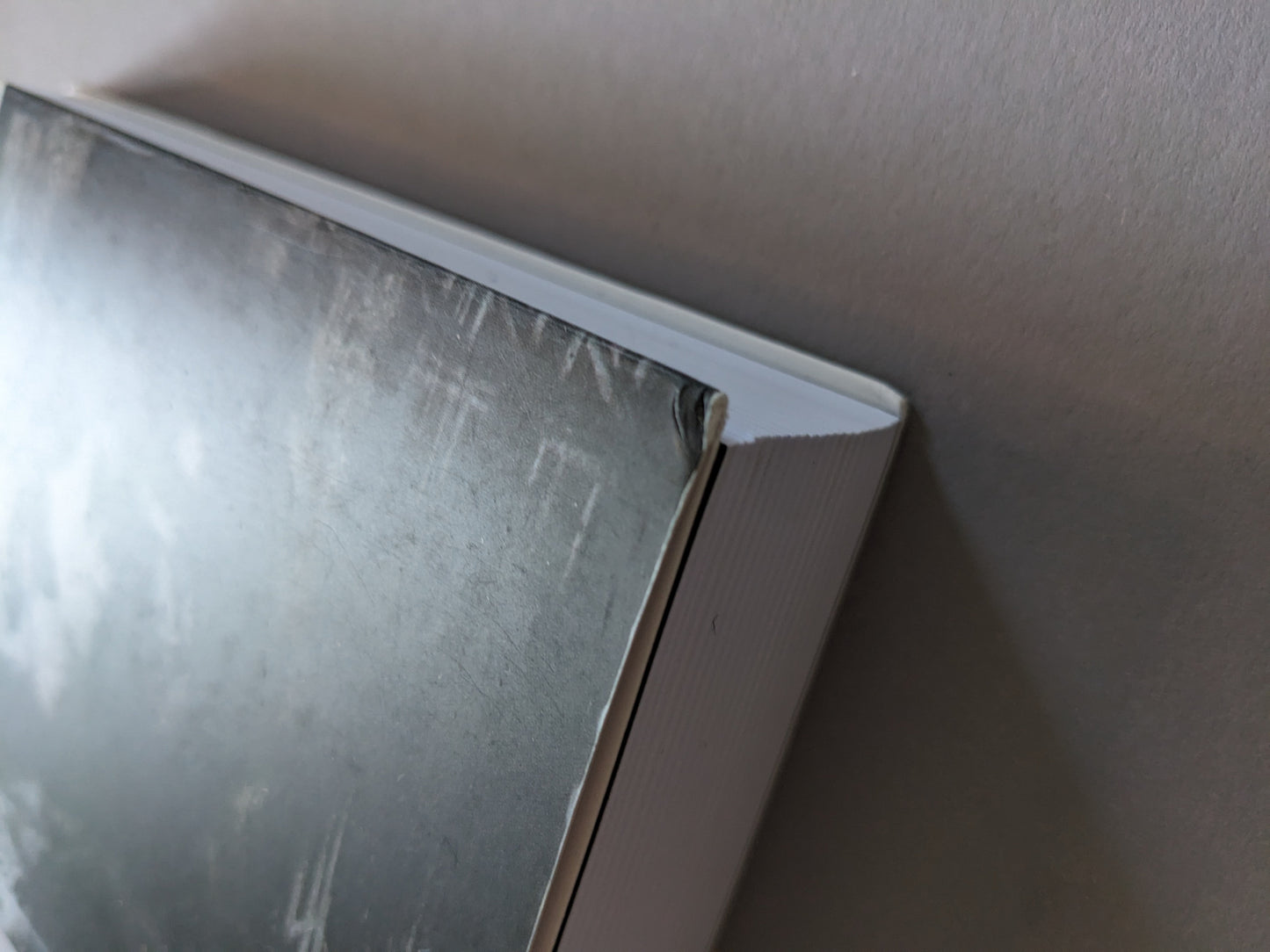 Corner dent on the back cover of Omnicide II – light wear visible.