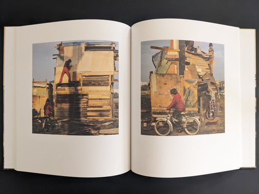 Open book spread with two colour photographs of children building tall wooden structures.