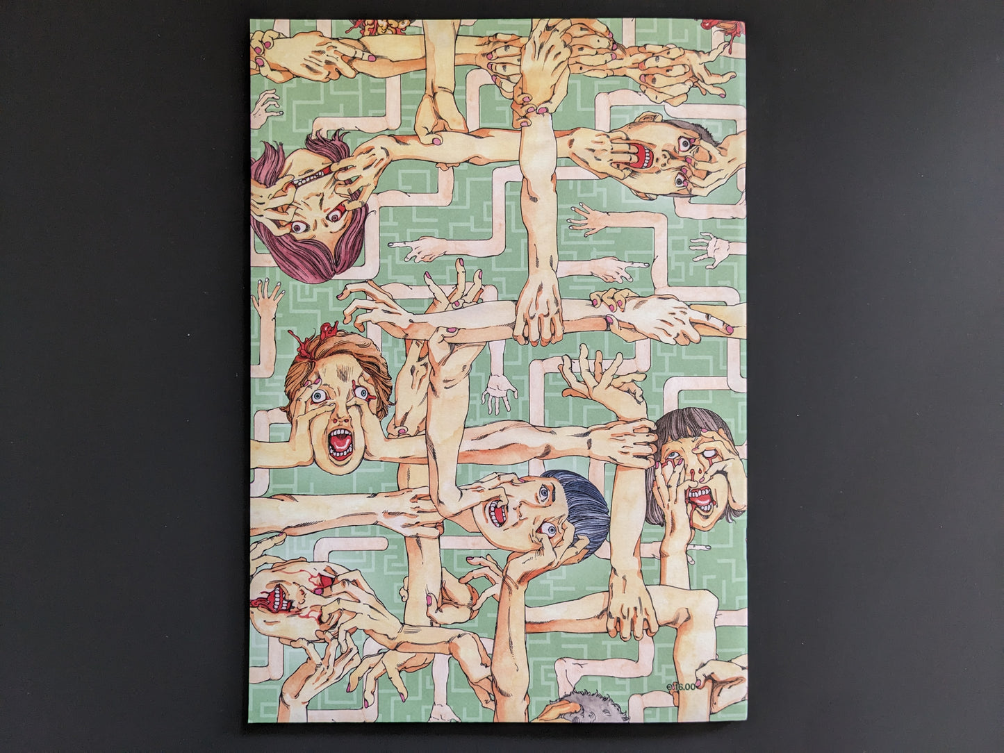 Back cover of "Parasitic City #0.3" by Shintaro Kago featuring surreal, overlapping faces and dismembered hands in a green and pink maze-like background