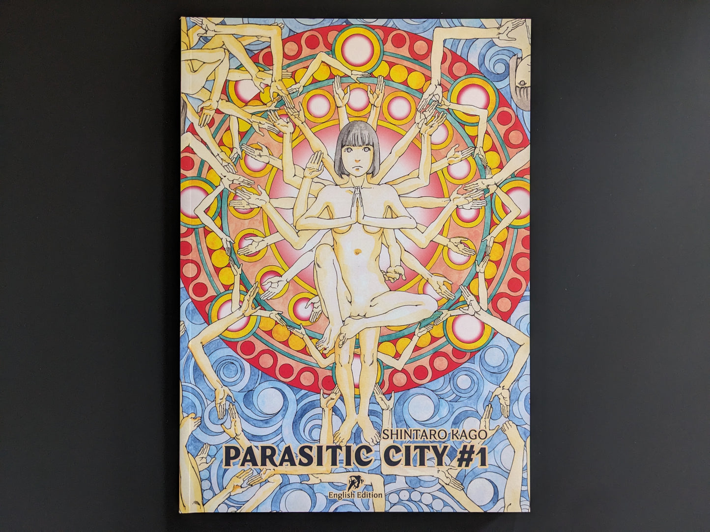 Front cover of "Parasitic City #1" by Shintaro Kago, featuring a surreal kaleidoscopic composition of female figures and religious symbolism