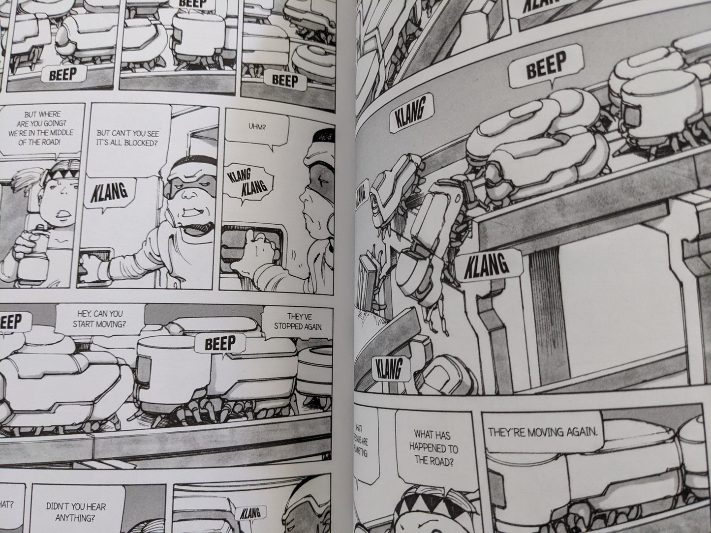Robot vehicles clogging the road in 'Parasitic City #2' as characters navigate traffic chaos.
