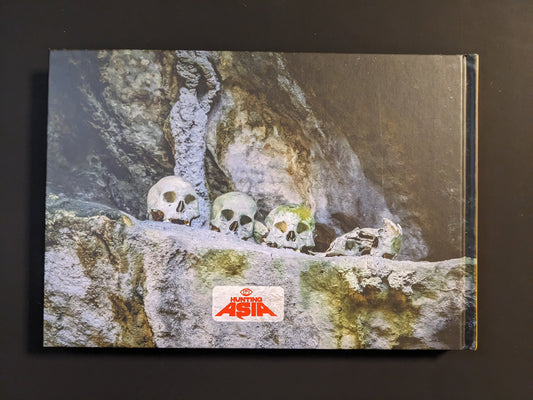 Back cover of the book "Rites & Ceremonies of South East Asia" by Vincent Peal showing skulls arranged in a cave.