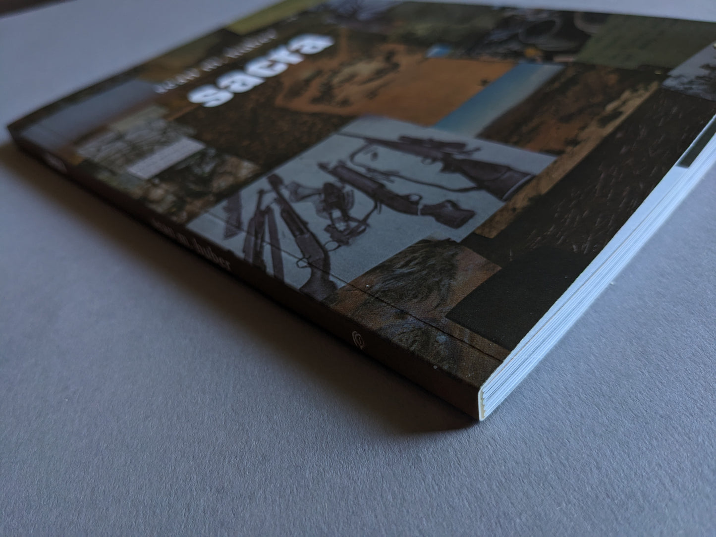 Spine view of "Sacra" showing the book's title and publisher