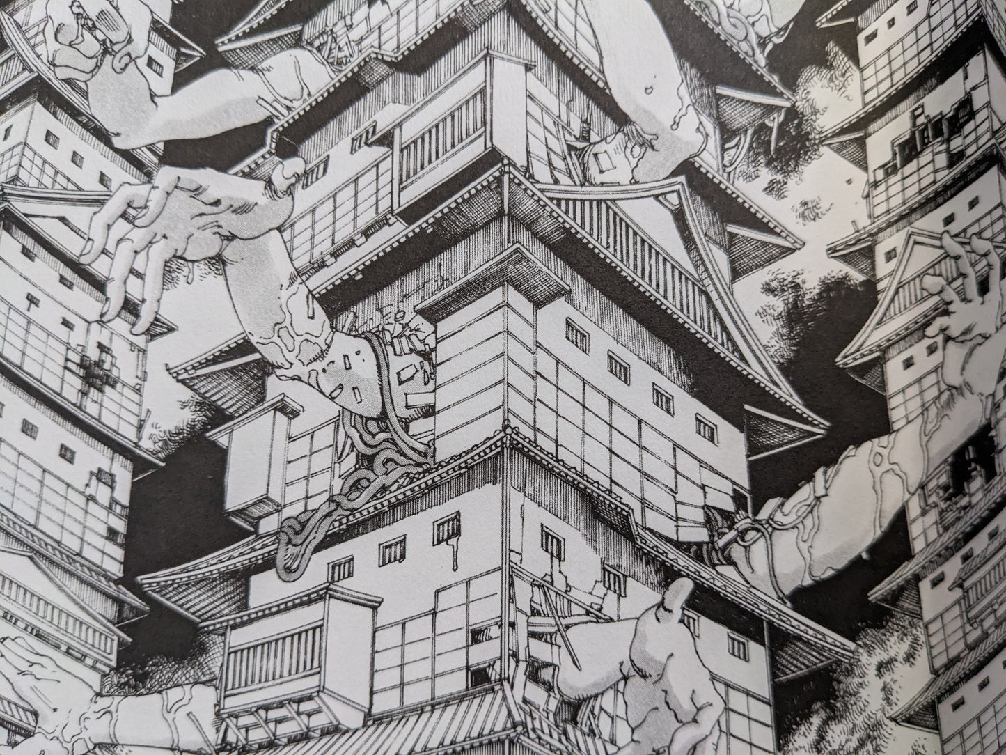 Surreal manga panel from Shintaro Kago's "The Twelve Sisters of the Never-ending Castle" featuring giant dismembered arms piercing traditional Japanese castle architecture