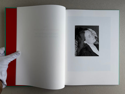 The Essential Solitude open to the title spread, with a small black-and-white portrait on the right page.