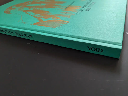 Spine of The Essential Solitude by Tereza Zelenkova, title and VOID logo stamped on green cloth hardcover.