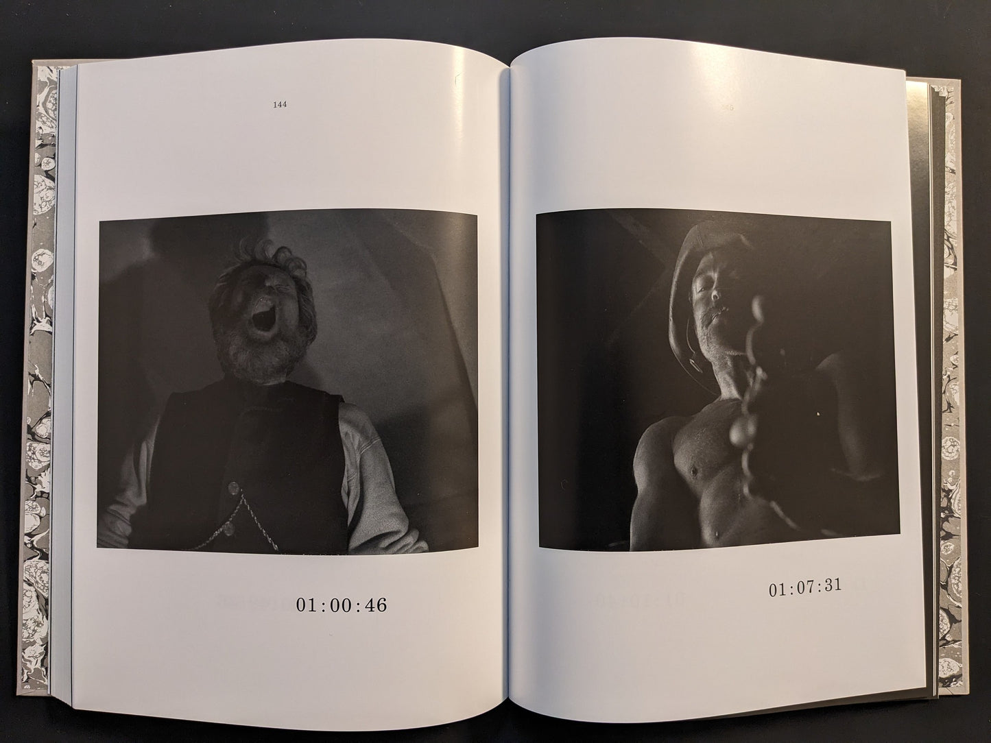 Double-page spread showing monochrome film frames from The Lighthouse in the screenplay book.