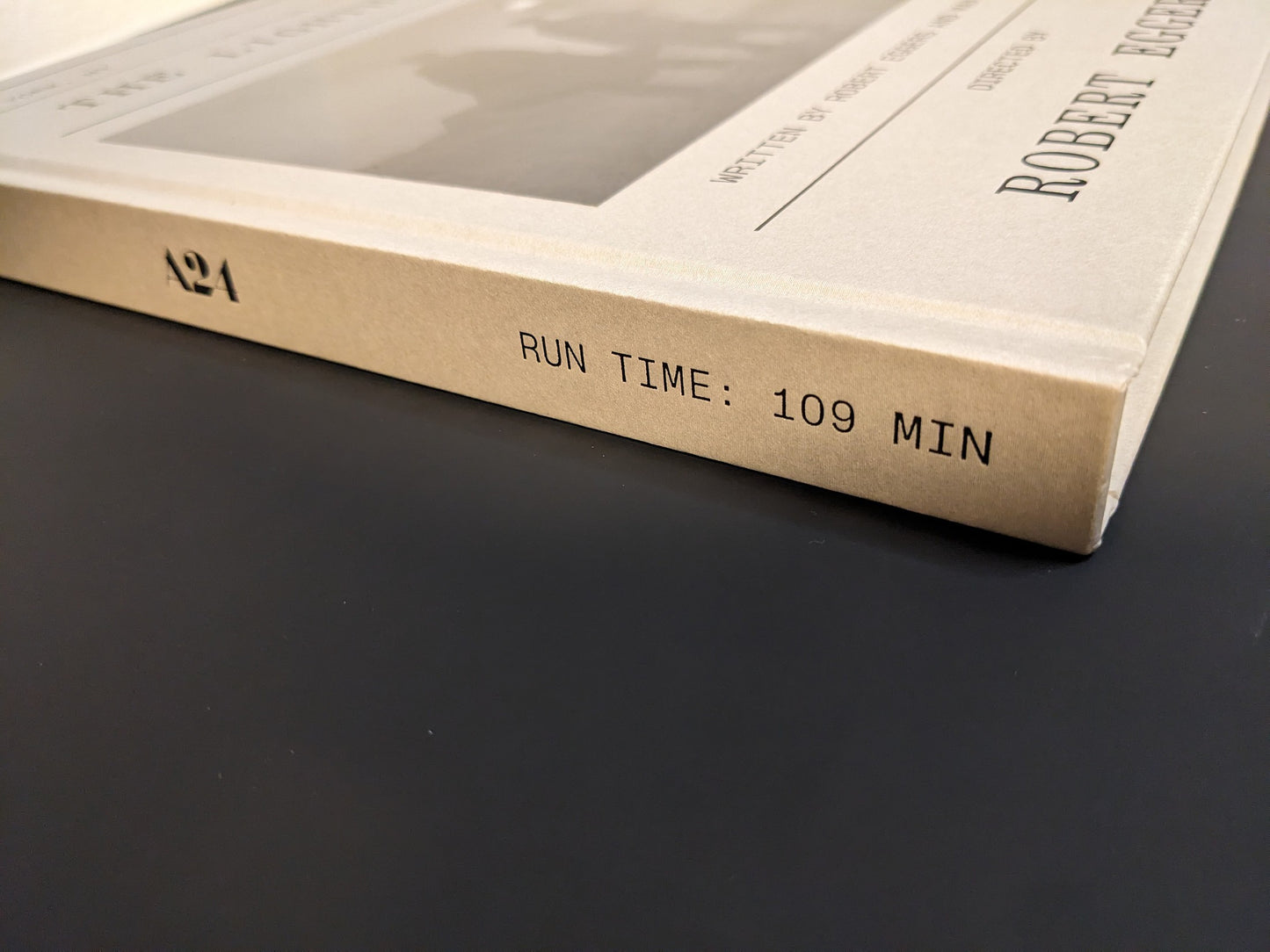 Book spine of The Lighthouse Screenplay Book showing A24 logo and “RUN TIME: 109 MIN.” inscription.