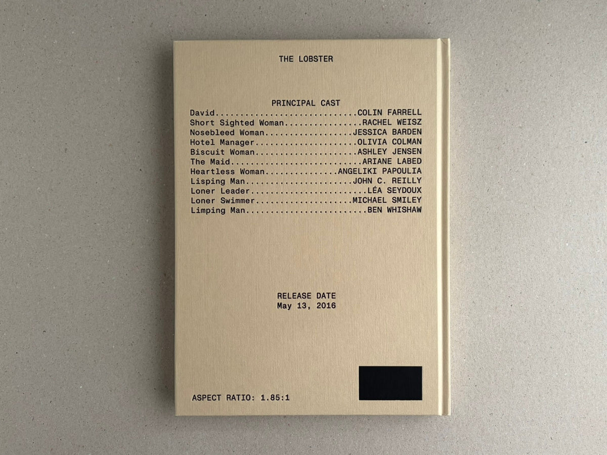 Front cover of The Lobster screenplay book, beige hardcover with cast list and release date printed on the cover.