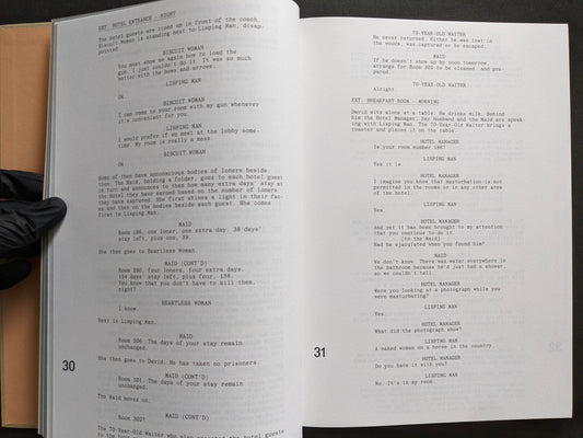 Interior screenplay spread from The Lobster featuring dialogue scenes set at the hotel entrance and breakfast room.