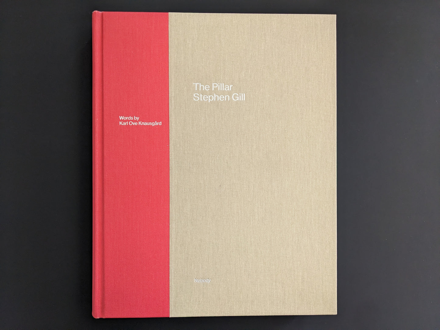 Front cover of The Pillar by Stephen Gill with text and words by Karl Ove Knausgård, cloth hardcover in red and beige