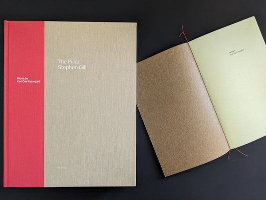 The Pillar by Stephen Gill with open book showing essay page, cloth-bound hardcover edition
