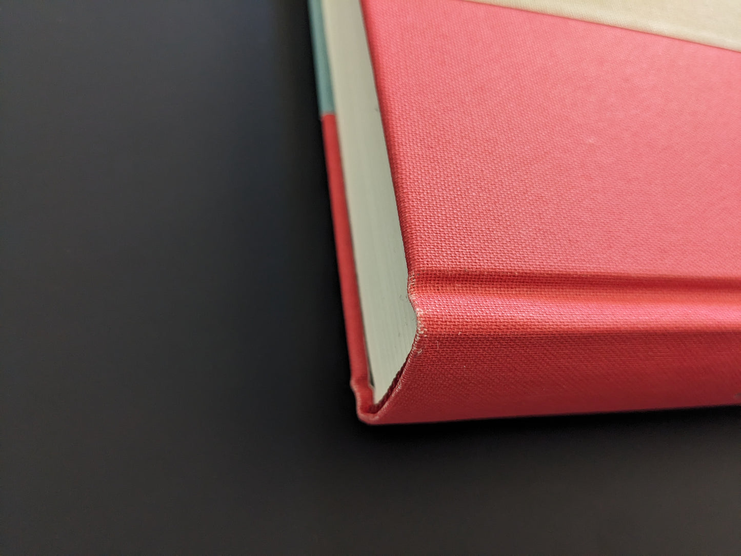 Detail of top corner of The Pillar by Stephen Gill, red cloth hardcover with slight edge wear