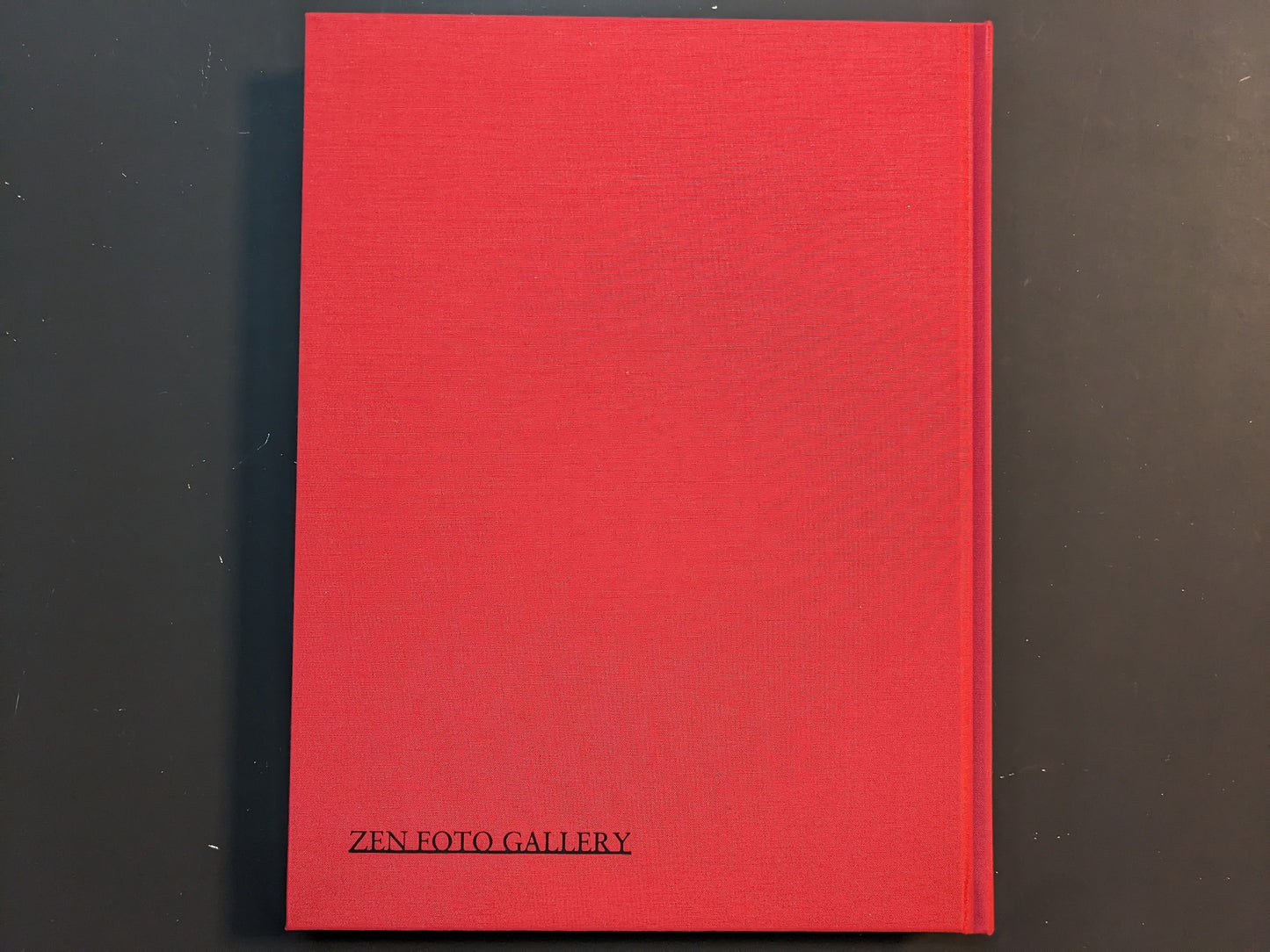 Back view of the red cloth hardcover of “TIBET” by Shinya Arimoto with the Zen Foto Gallery imprint at the bottom.